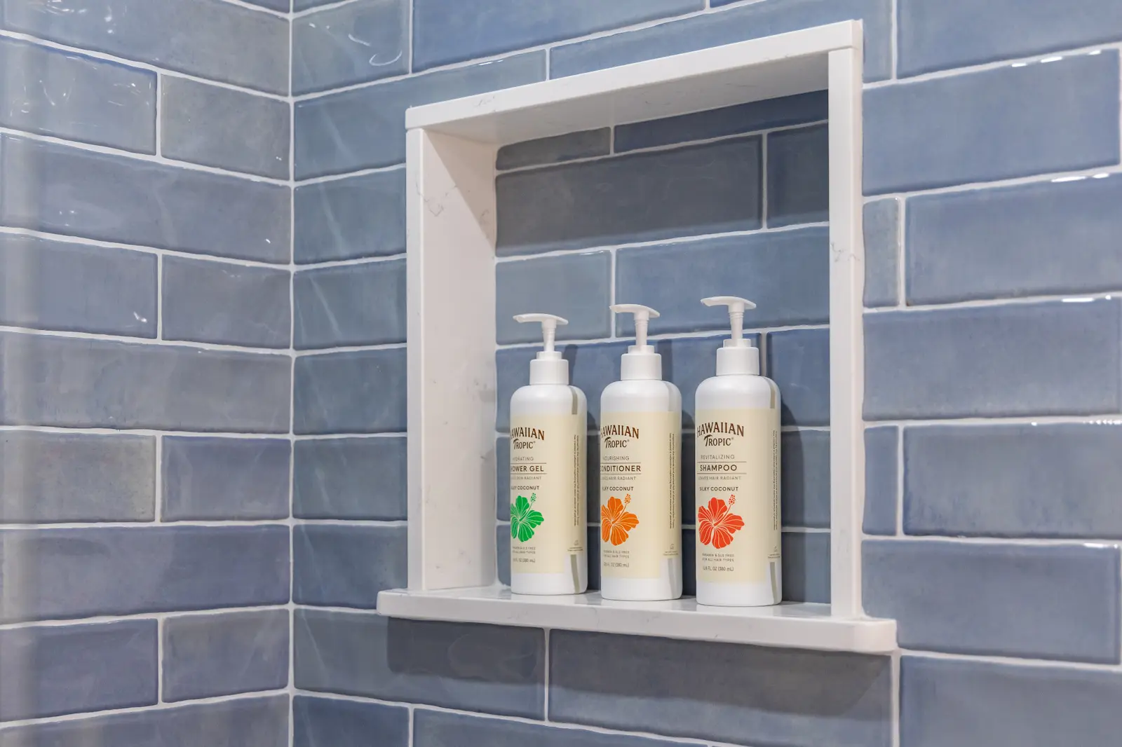 Shampoo, conditioner and shower gel arranged in a vacation rental bathroom